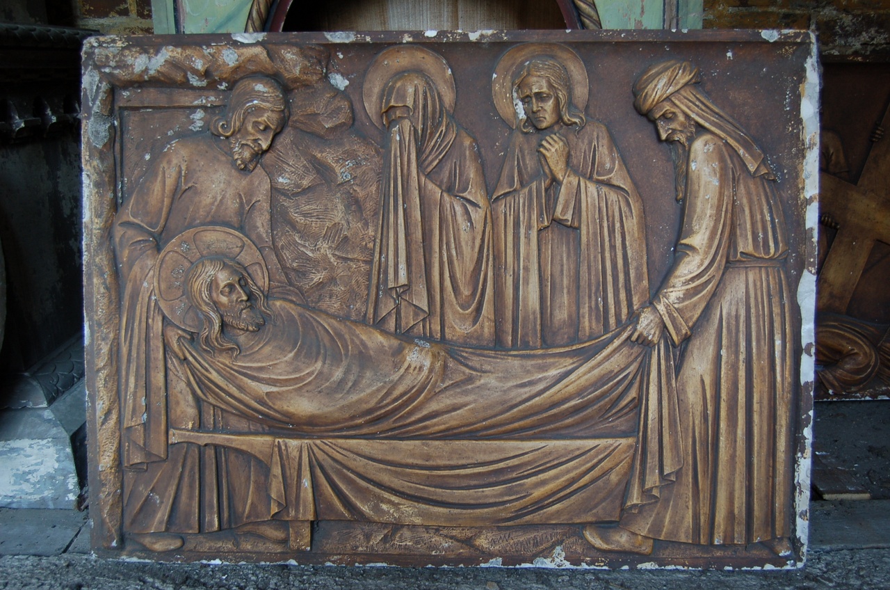 Kruiswegstatie: Jezus wordt in het graf gelegd